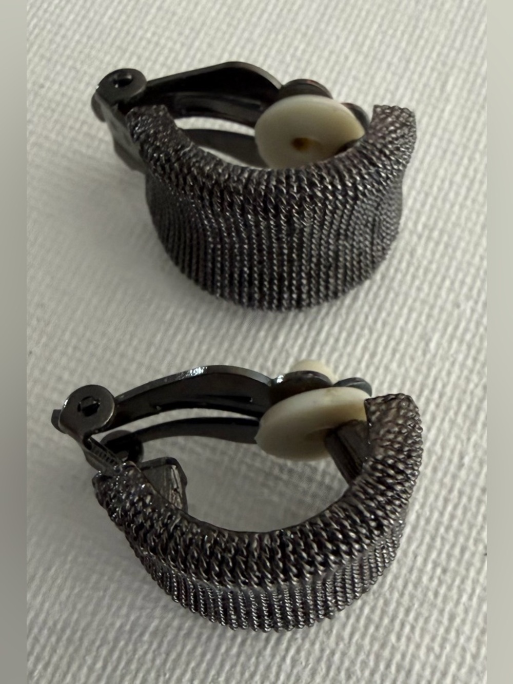 Woven metal clip-on earrings in gunmetal color